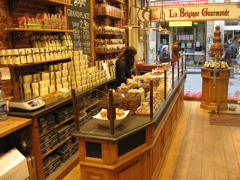 A Fountain of melted chocolate is seen just under the store sign