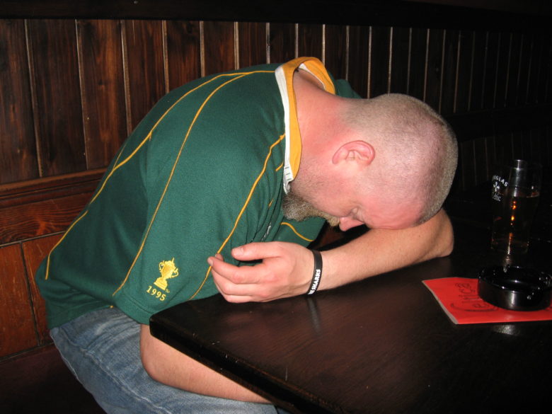 Customer sleeping on a table in Celtica pub drunk Brussels drunk